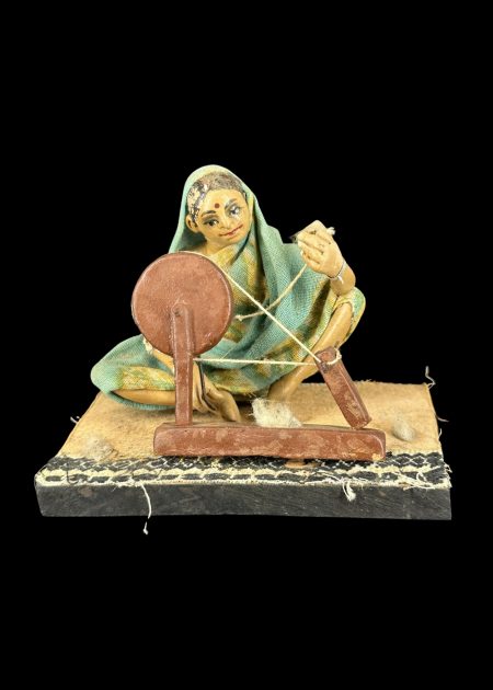 TRADITIONAL WOMAN WITH SPINNING WHEEL