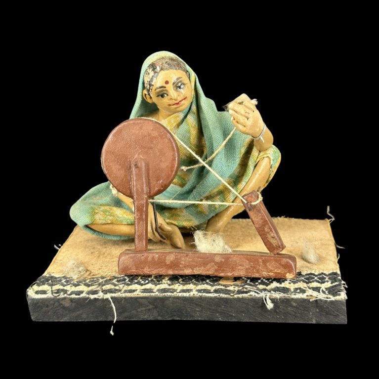 TRADITIONAL WOMAN WITH SPINNING WHEEL
