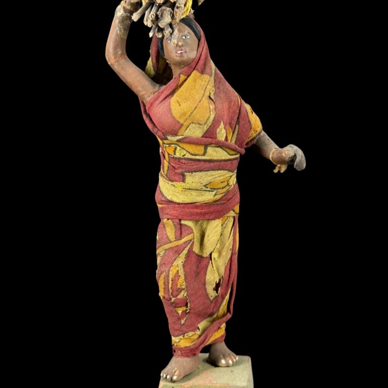 VILLAGE WOMAN CARRYING FIREWOOD