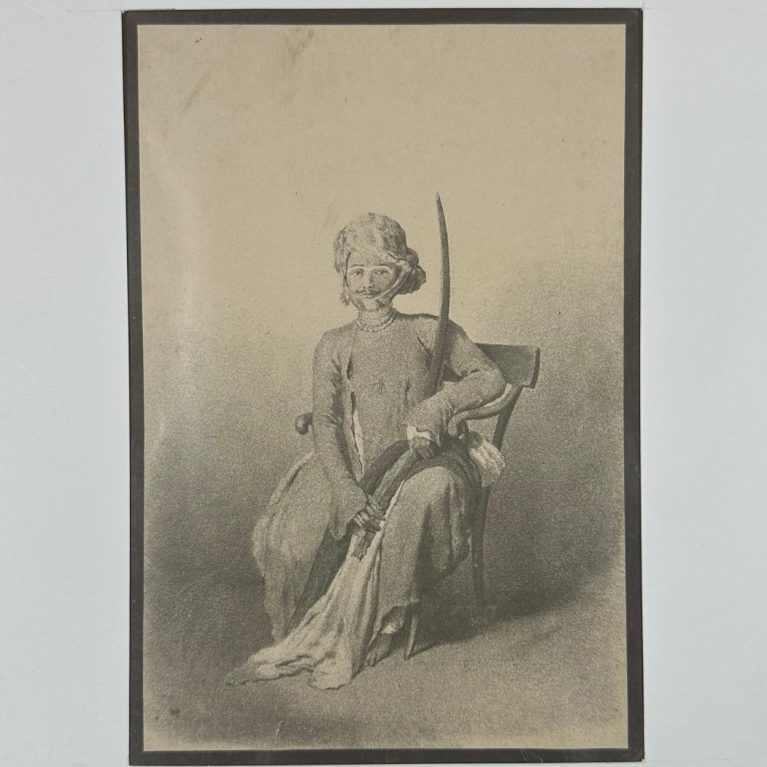 A SEATED INDIAN SWORDSMAN
